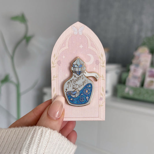 Oopsie Damaged Moon Dust Elixir Enamel Pin